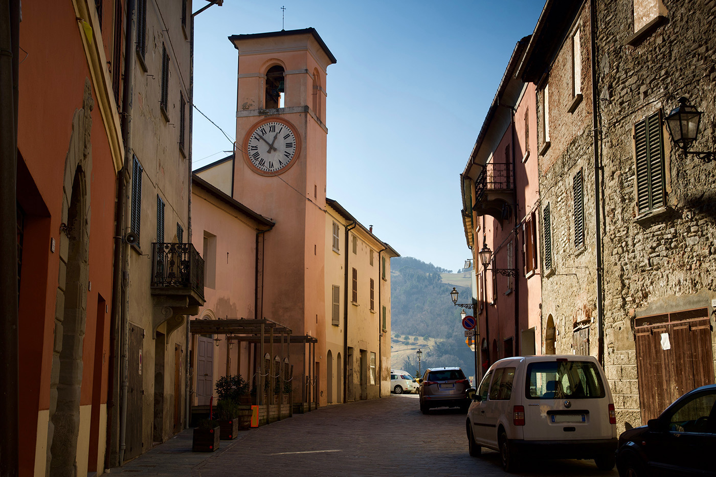 La Torre Civica di Casola Valsenio, centro della Valle del Senio. Si vede una via con una torre e l'orologio.