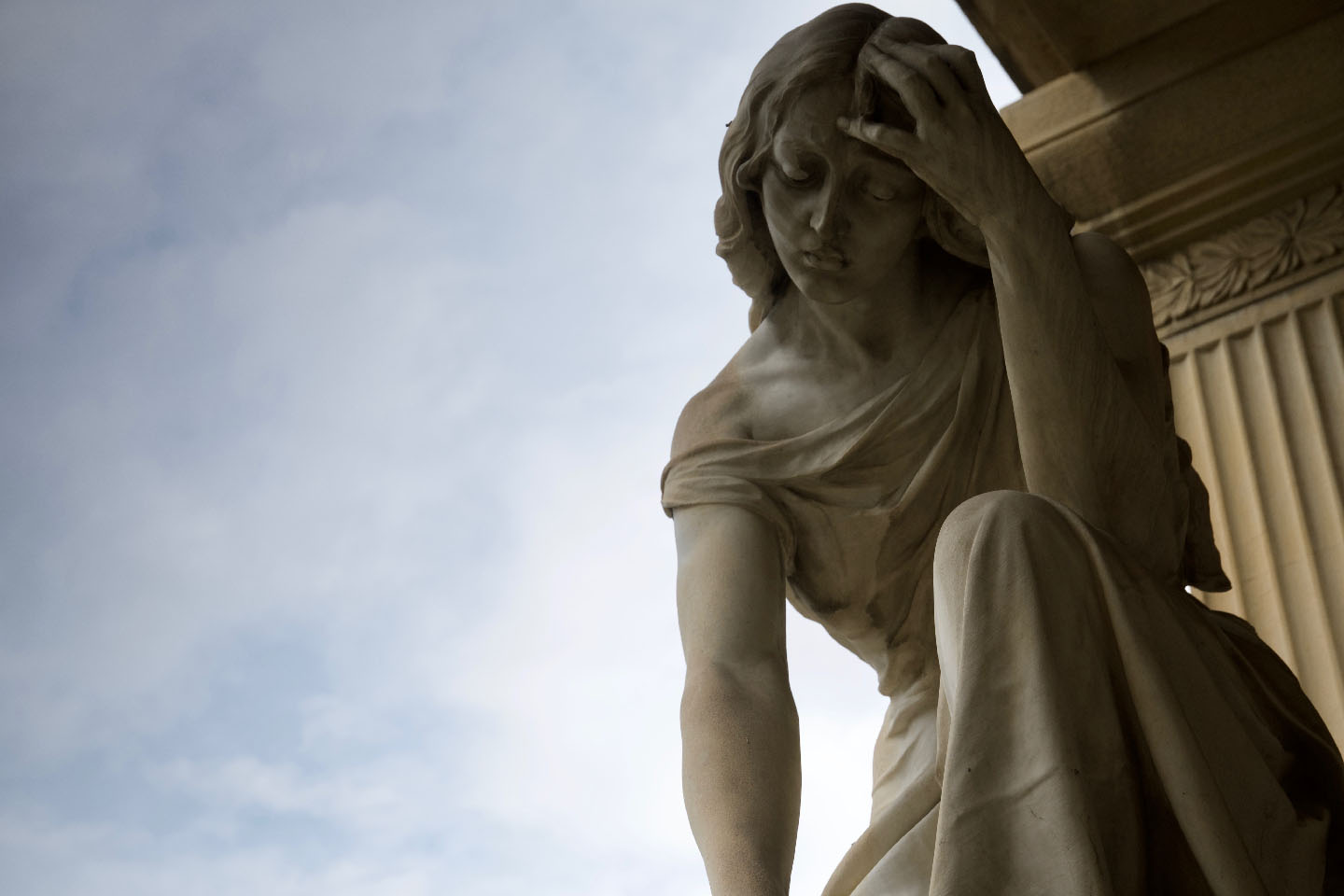 Uno dei monumenti del cimitero della Certosa. Si vede una scultura in marmo di una giovane donna sconvolta dal dolore.